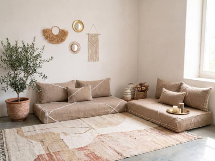 Beige Moroccan floor sofa set in a minimalist boho living room with textured cushions, neutral rug, wall decor, and natural sunlight.