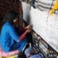 Berber Weaver on the weaving machine making moroccan rugs