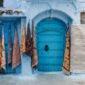 Moroccan rugs hanging near a door in Chefchaouen