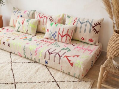 Colorful kilim floor sofa cushion set — Amazigh geometric symbols in pink, green, red, cobalt on handwoven cream kilim