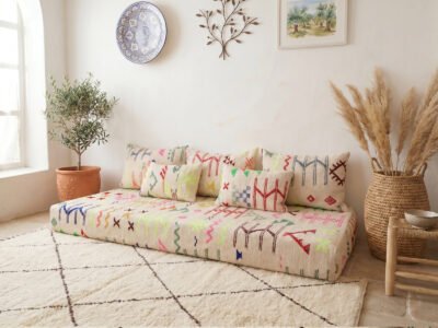 Colorful kilim floor sofa and matching cushion set, multicolor Berber motifs on cream ground, Moroccan interior