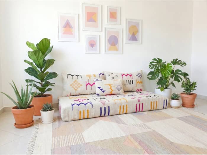 Ecru flatweave sofa multicolor motif detail – fuchsia saffron indigo charcoal Berber symbols – Asala Living
