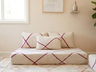 Fuchsia diamond Berber floor sofa in handwoven ivory wool with matching diamond-pattern cushions