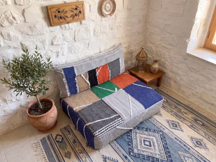 Color block hanbel floor sofa seen from above, showing green, orange and blue flatweave panels with white cord stitching