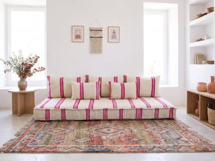 Ivory pink stripe floor sofa in a bright Marrakech living room with terracotta pottery and olive branches