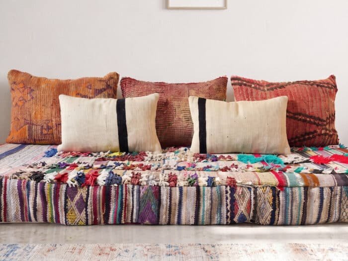 Boucherouite rag floor sofa close-up showing colorful upcycled tufts and Berber rag stripe detail