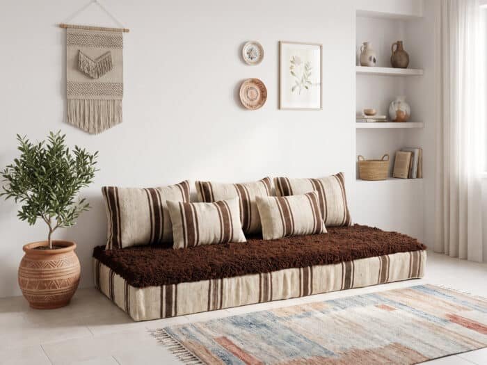 Coffee stripe hanbel floor sofa with ivory cushions and brown shag top in a bright boho living room