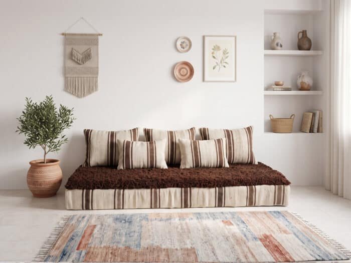 Brown shag floor sofa with striped ivory cushions and chocolate wool top in a bright boho living room