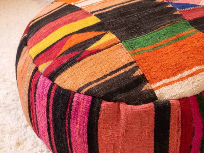 Close-up of Chevron Kilim Pouf showing diagonal stripes, triangle motifs and bold black bands