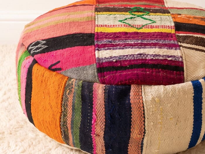 Close-up of Eclectic Kilim Pouf showing an embroidered green diamond and mixed vintage kilim panels