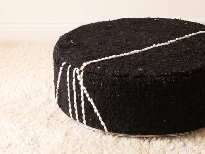 Morocco Black Ottoman close-up showing plush black cotton pile with white Berber cord lines