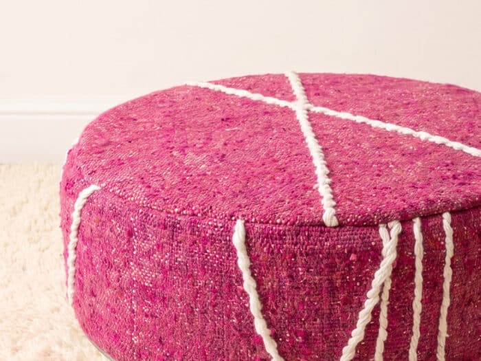 Morocco Pink Ottoman close-up showing fuchsia flatweave and white Berber cord star pattern