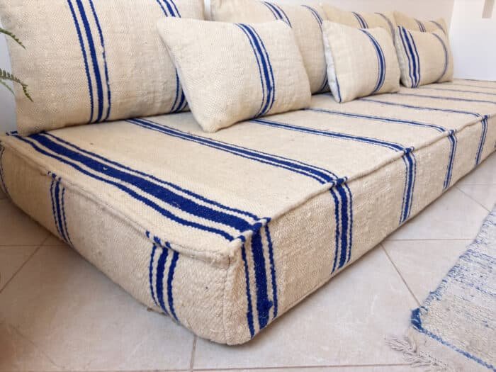 Navy striped kilim floor sofa close-up showing handwoven flatweave and cobalt stripe detail
