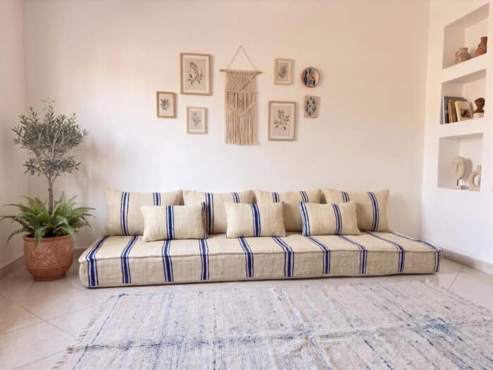 Navy striped kilim floor sofa in ivory wool with matching cushions in a bright Moroccan living room