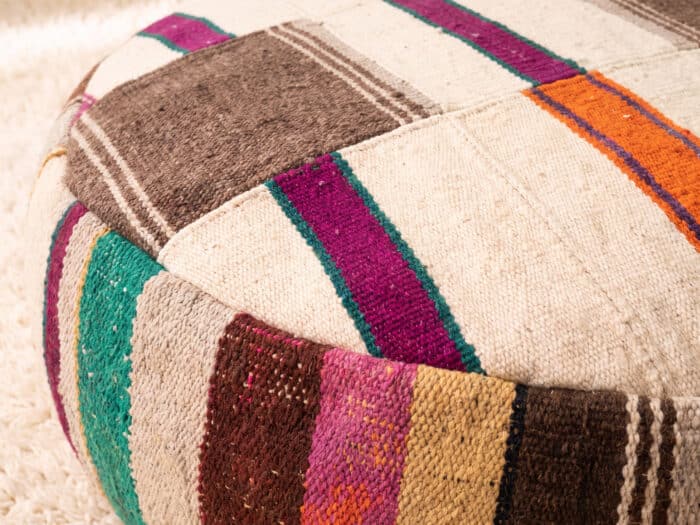 Close-up of Neutral Kilim Pouf showing cream and taupe panels crossed by fine coloured wool stripes