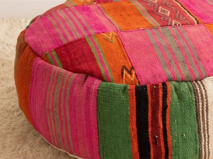 Close-up of Pink Kilim Pouf showing fuchsia stripes, orange panels and woven diamond motifs