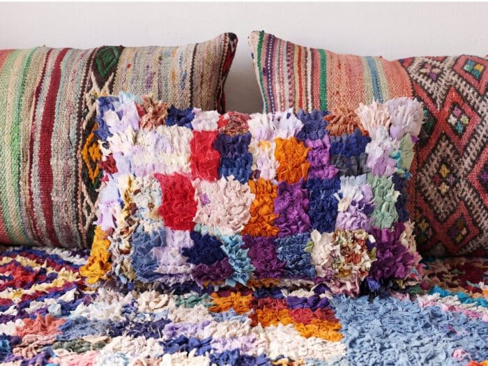 Plush boucherouite floor couch close-up showing colorful upcycled rag tufts and diamond motifs