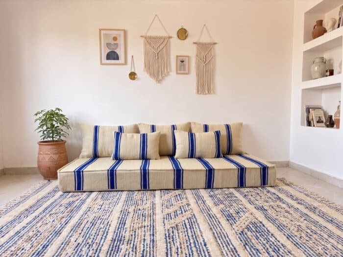 Royal blue striped floor couch cushions in ivory wool showing bold cobalt stripe flatweave detail