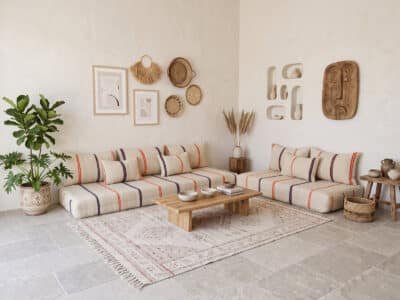L-shaped Moroccan floor sofa with orange and navy stripes in a cream corner lounge – Asala Living