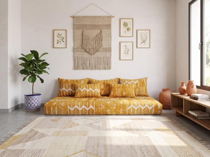 Mustard yellow kilim majlis sofa from above in a sunlit room with a beige geometric rug