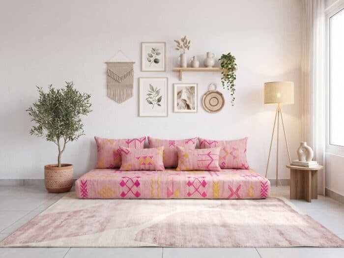 Pink and marigold floor sofa with magenta Berber motifs and five pillows, front view