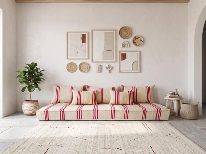 Triple stripe Moroccan floor couch set, front view below a gallery wall of woven baskets and textured art