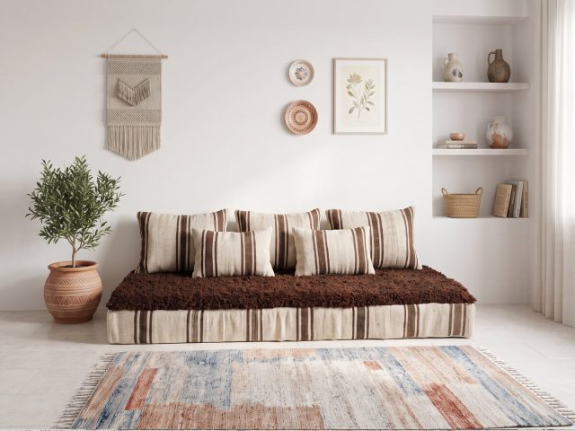 Brown shag floor sofa with striped ivory cushions and chocolate wool top in a bright boho living room