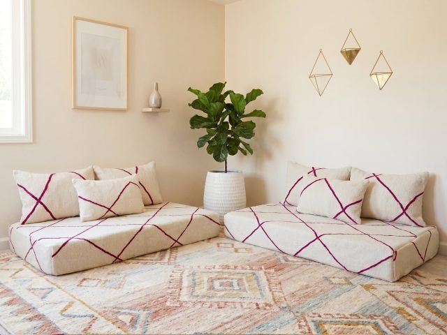 Fuchsia diamond Berber floor sofa pair in ivory wool styled facing in a neutral Moroccan-inspired living room