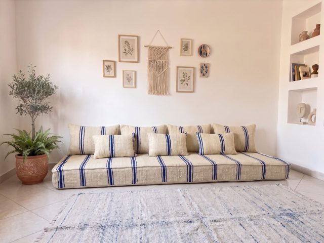 Navy striped kilim floor sofa in ivory wool with matching cushions in a bright Moroccan living room