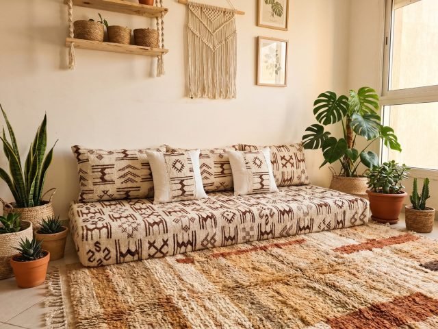 Ivory Azilal floor sofa with brown Berber symbols in a plant-filled boho living room – Asala Living